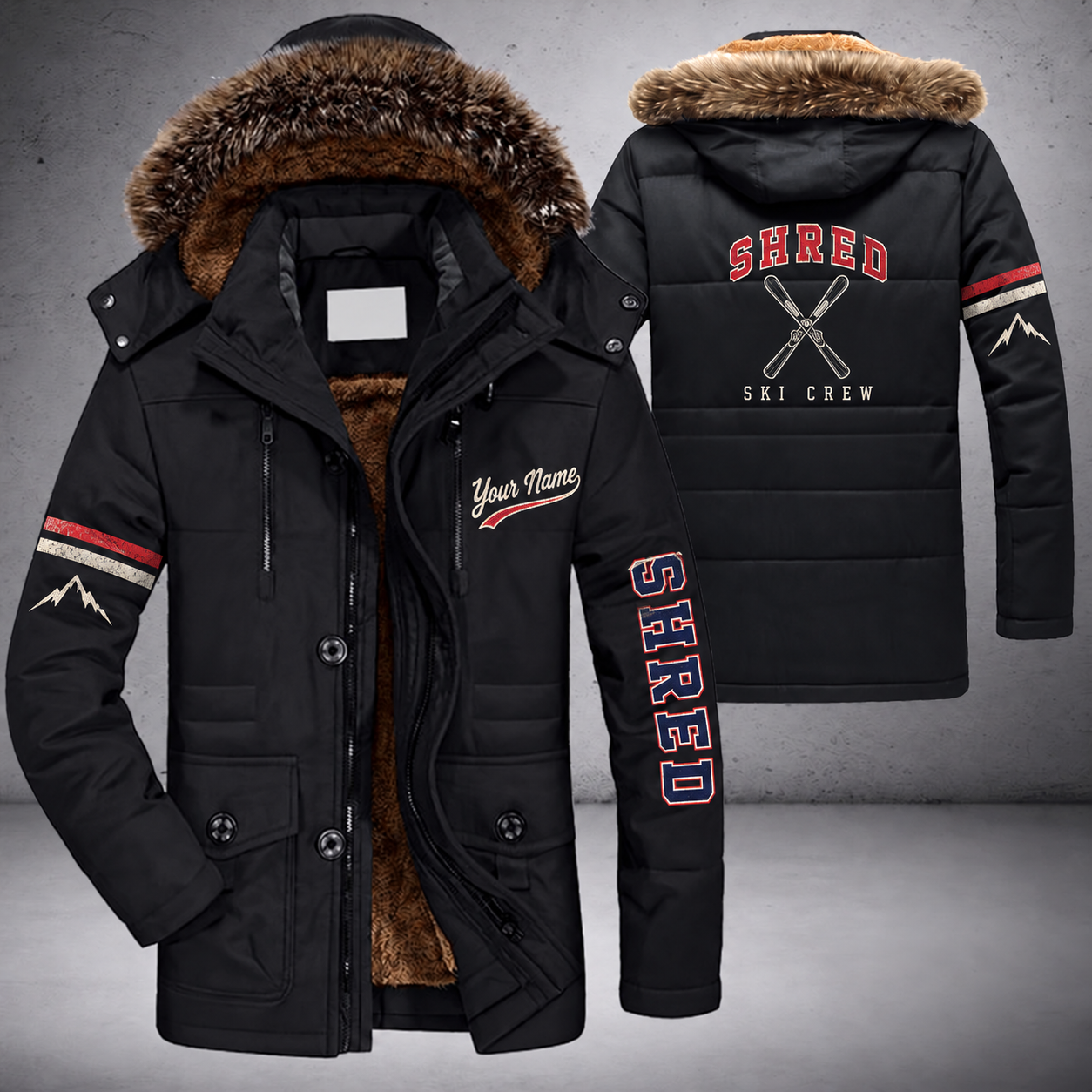 Black parka jacket with a faux-fur hood, crossed skis on the back, "SHRED" lettering and a custom name in script on the chest